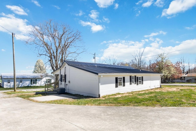 view of side of property featuring metal roof