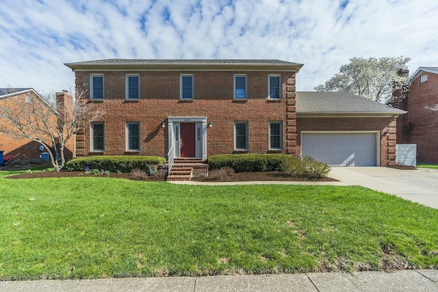 colonial house with driveway, brick siding, a garage, and a front yard