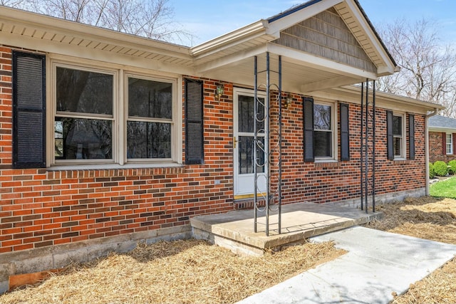 doorway to property featuring brick siding