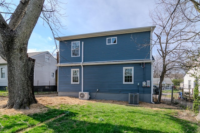 948 Meadow Ln, Lexington, KY 40505 - back of property featuring central air condition unit, a lawn, ac unit, and fence