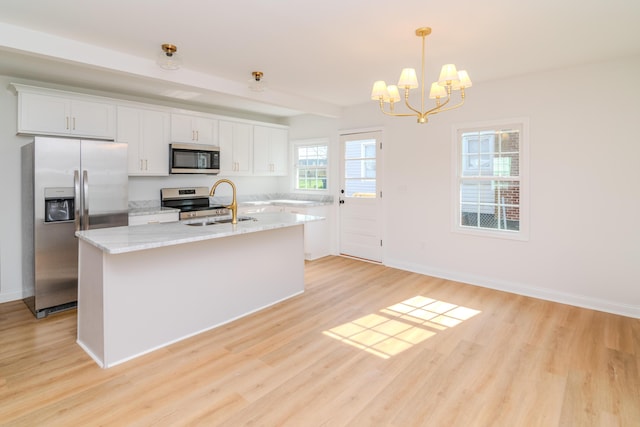 948 Meadow Ln, Lexington, KY 40505 - kitchen featuring light wood-style floors, white cabinets, stainless steel appliances, and a chandelier