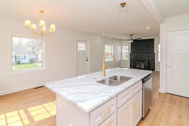948 Meadow Ln, Lexington, KY 40505 - kitchen with white cabinets, visible vents, a large fireplace, a sink, and stainless steel dishwasher