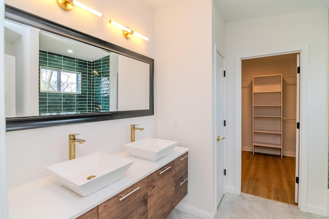 948 Meadow Ln, Lexington, KY 40505 - full bathroom with baseboards, double vanity, a sink, and a walk in closet