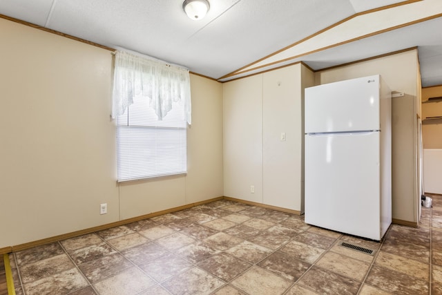 2190 Bluebank Rd, Morehead, KY 40351 - interior space featuring baseboards, lofted ceiling, visible vents, and freestanding refrigerator