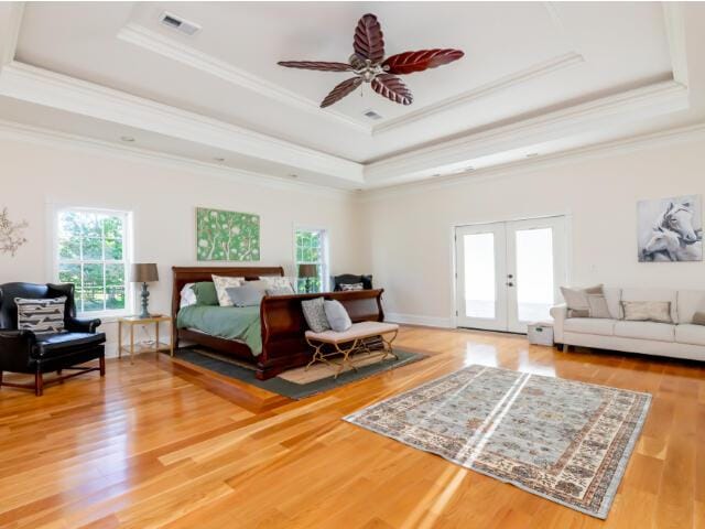 4950 Jennie Kate Ln, Lexington, KY 40510 - bedroom featuring visible vents, ornamental molding, light wood-type flooring, a tray ceiling, and french doors