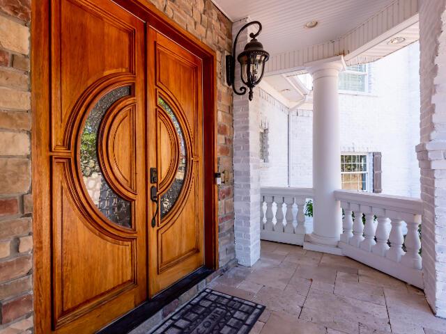 4950 Jennie Kate Ln, Lexington, KY 40510 - doorway to property with covered porch and stone siding
