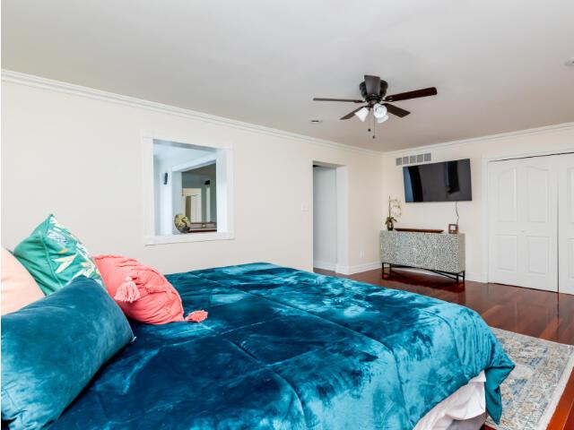 4950 Jennie Kate Ln, Lexington, KY 40510 - bedroom featuring a closet, visible vents, ornamental molding, wood finished floors, and ceiling fan