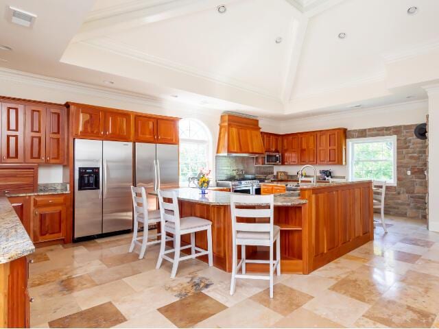 4950 Jennie Kate Ln, Lexington, KY 40510 - kitchen featuring crown molding, brown cabinets, stainless steel appliances, a sink, and a spacious island