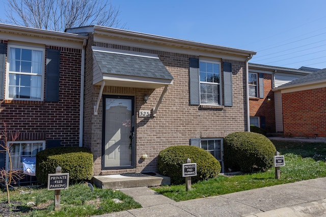 property entrance featuring brick siding
