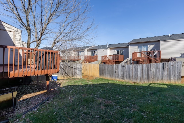 view of yard featuring a residential view, a wooden deck, and fence