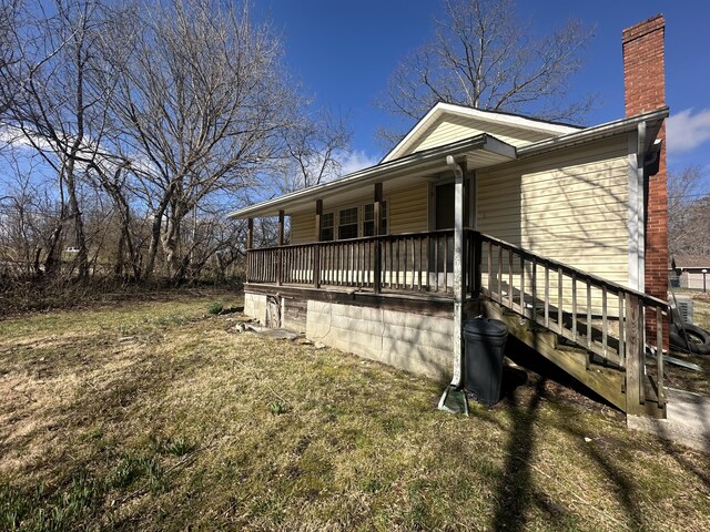 34 Bridge Fork Rd, Whitley City, KY 42653 - view of side of property featuring a chimney and covered porch