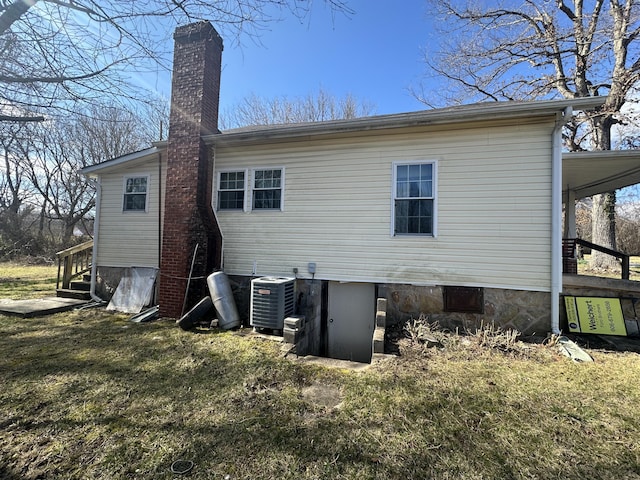 34 Bridge Fork Rd, Whitley City, KY 42653 - rear view of property with a lawn, central AC unit, and a chimney