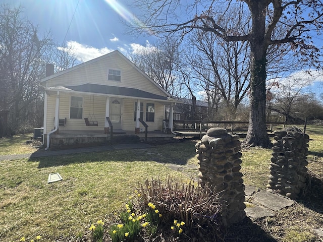 34 Bridge Fork Rd, Whitley City, KY 42653 - bungalow-style home featuring covered porch, a chimney, and a front lawn