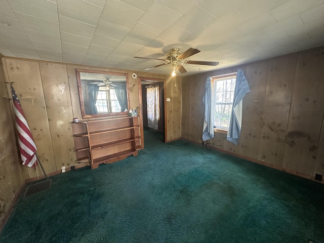 34 Bridge Fork Rd, Whitley City, KY 42653 - carpeted empty room featuring a ceiling fan, wood walls, and visible vents
