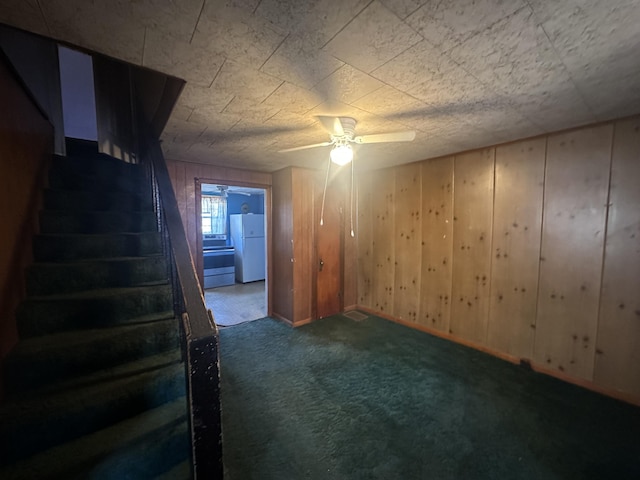 34 Bridge Fork Rd, Whitley City, KY 42653 - basement featuring stairway, a ceiling fan, freestanding refrigerator, wood walls, and carpet