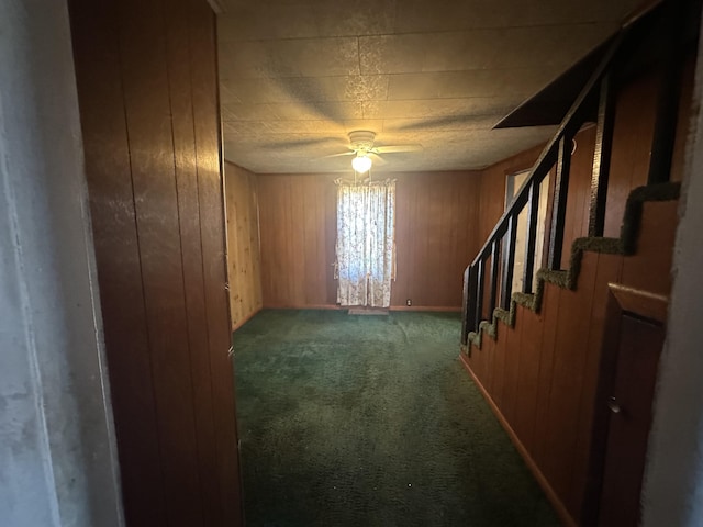 34 Bridge Fork Rd, Whitley City, KY 42653 - empty room with ceiling fan, wood walls, carpet floors, and stairway