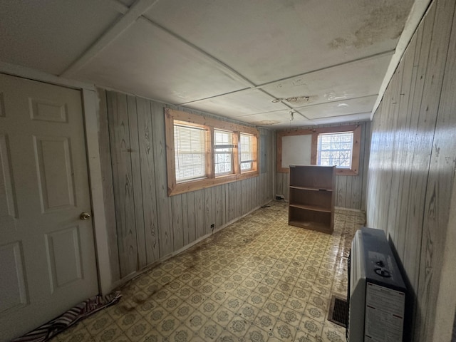 34 Bridge Fork Rd, Whitley City, KY 42653 - empty room featuring heating unit, wood walls, baseboards, and light floors