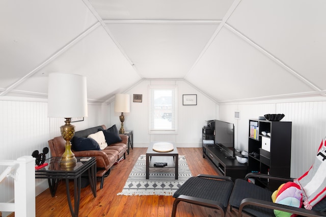 living area featuring vaulted ceiling and hardwood / wood-style flooring