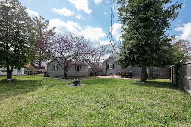 view of yard featuring a fenced backyard, an outdoor fire pit, and a patio area