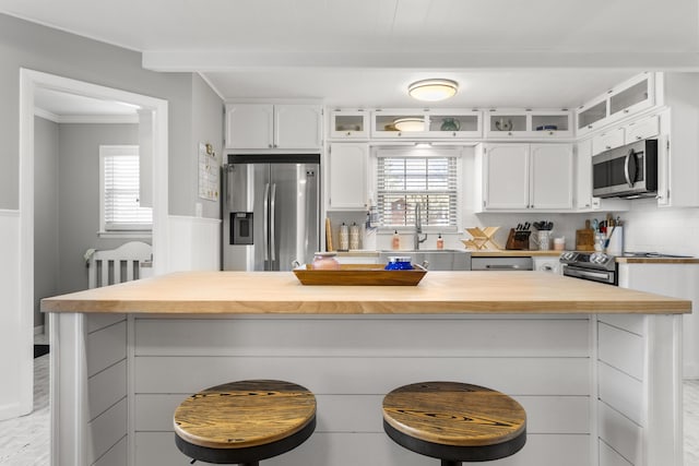 29 Quails Run Ln, West Liberty, KY 41472 - kitchen with stainless steel appliances, a sink, butcher block counters, white cabinetry, and a kitchen bar