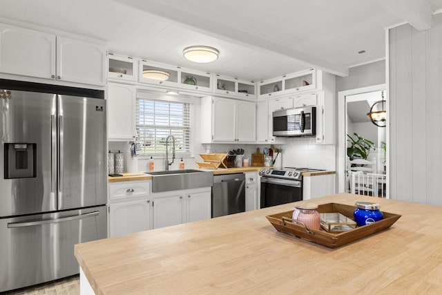 29 Quails Run Ln, West Liberty, KY 41472 - kitchen with appliances with stainless steel finishes, butcher block counters, a sink, white cabinetry, and tasteful backsplash