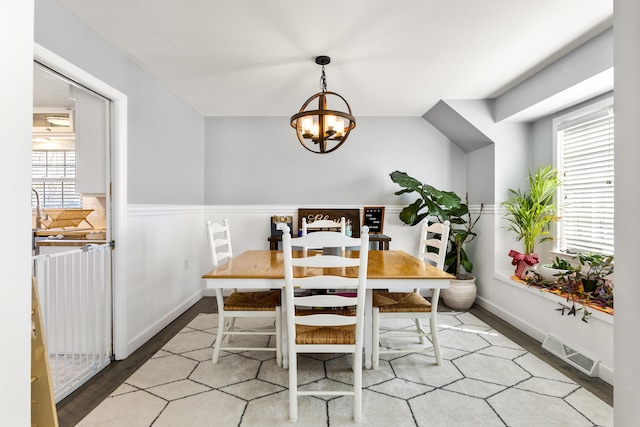 29 Quails Run Ln, West Liberty, KY 41472 - dining room with a chandelier, plenty of natural light, a wainscoted wall, wood finished floors, and baseboards