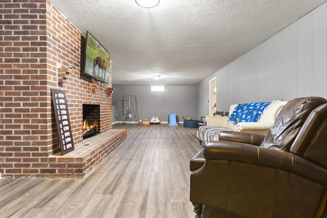 29 Quails Run Ln, West Liberty, KY 41472 - living room with wood finished floors, a fireplace, and a textured ceiling