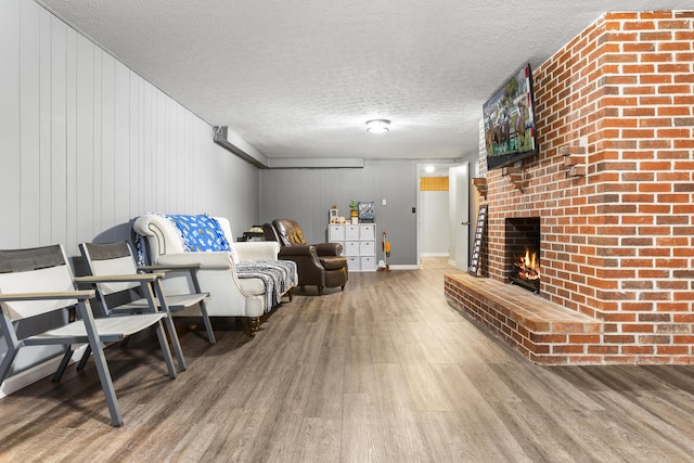 29 Quails Run Ln, West Liberty, KY 41472 - living area with wood finished floors, a textured ceiling, a fireplace, and wood walls