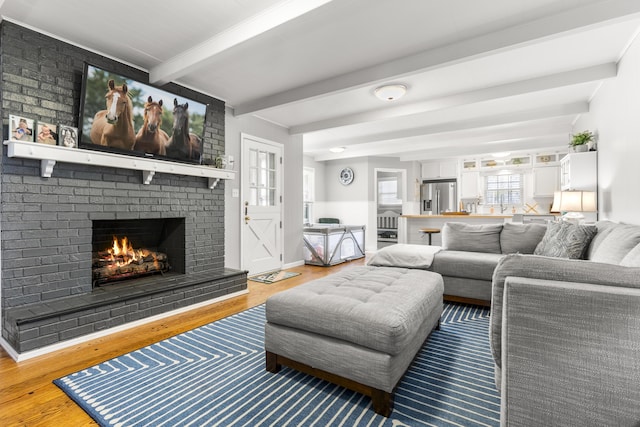 29 Quails Run Ln, West Liberty, KY 41472 - living room featuring a fireplace, wood finished floors, and beam ceiling