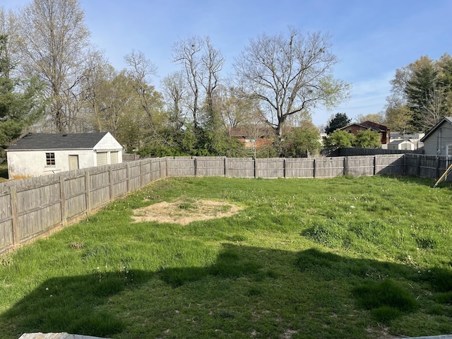 view of yard with fence and a garage