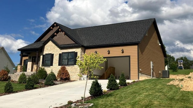craftsman-style home featuring driveway, stone siding, central air condition unit, a front lawn, and a garage