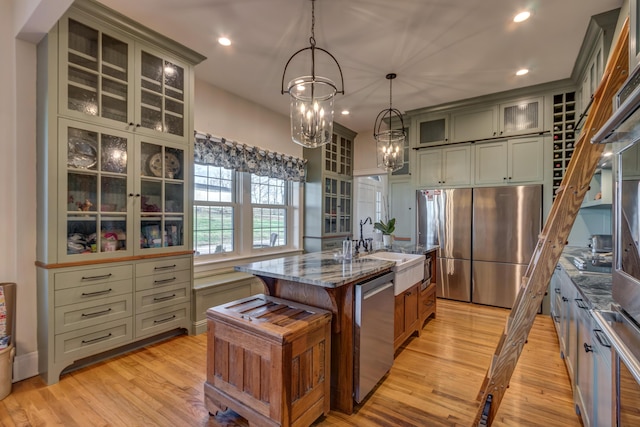 443 Hutchison Rd, Paris, KY 40361 - kitchen featuring light wood-style flooring, a kitchen island with sink, stainless steel appliances, recessed lighting, and dark stone countertops