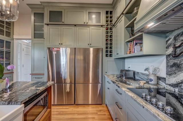 443 Hutchison Rd, Paris, KY 40361 - kitchen with dark stone counters, appliances with stainless steel finishes, glass insert cabinets, open shelves, and light wood-style floors