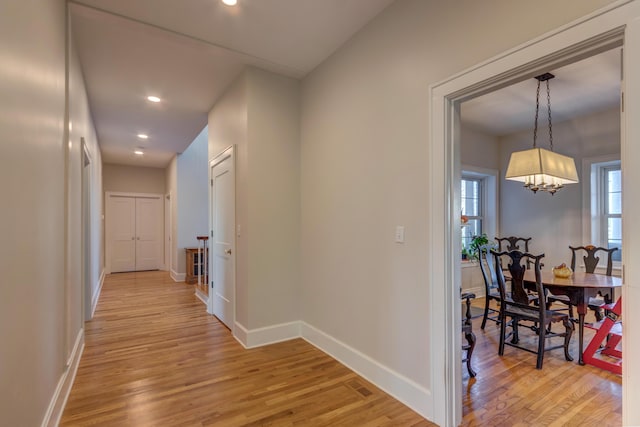 443 Hutchison Rd, Paris, KY 40361 - hallway with a notable chandelier, baseboards, and light wood-type flooring