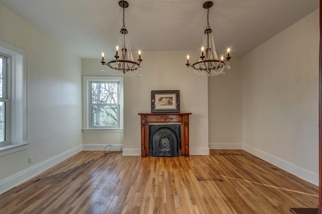 443 Hutchison Rd, Paris, KY 40361 - unfurnished living room featuring a notable chandelier, baseboards, and wood finished floors