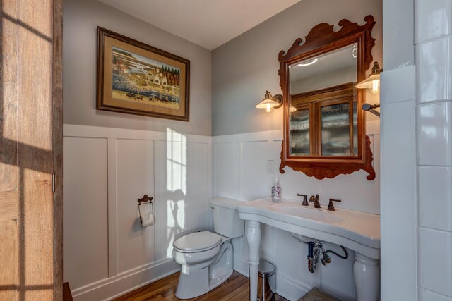 443 Hutchison Rd, Paris, KY 40361 - bathroom with wainscoting, wood finished floors, toilet, and a decorative wall