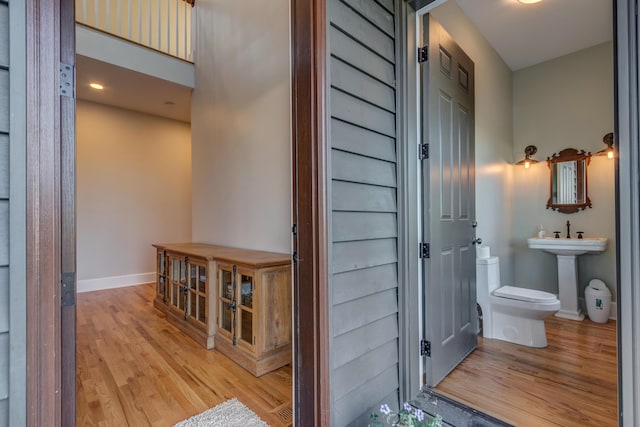 443 Hutchison Rd, Paris, KY 40361 - bathroom with toilet, a sink, baseboards, and wood finished floors