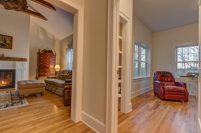 443 Hutchison Rd, Paris, KY 40361 - sitting room with baseboards, vaulted ceiling with beams, a glass covered fireplace, and light wood finished floors