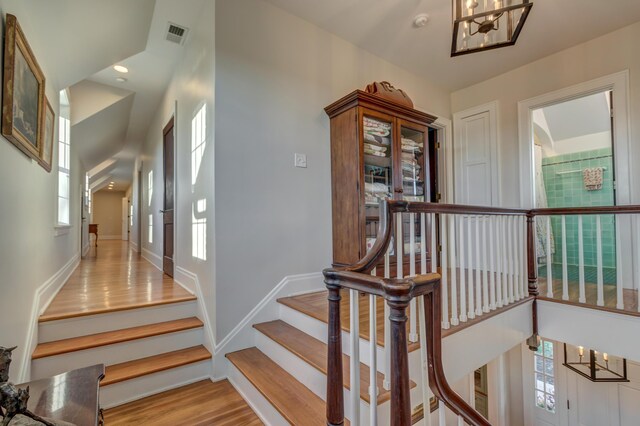 443 Hutchison Rd, Paris, KY 40361 - stairs featuring baseboards, visible vents, wood finished floors, and a chandelier