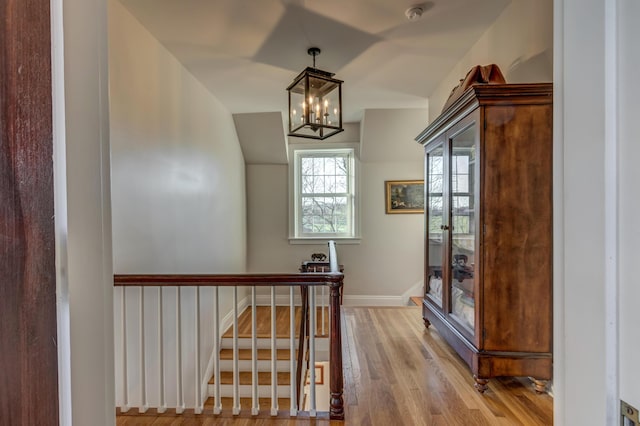 443 Hutchison Rd, Paris, KY 40361 - stairway with baseboards, wood finished floors, and an inviting chandelier