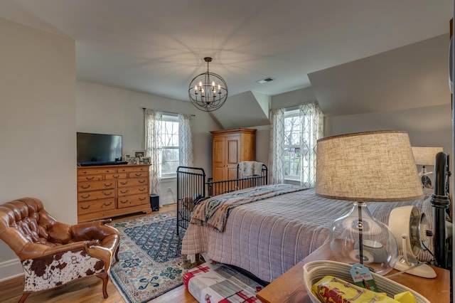 443 Hutchison Rd, Paris, KY 40361 - bedroom featuring visible vents, wood finished floors, multiple windows, and a notable chandelier