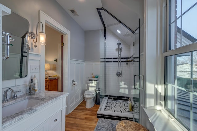 443 Hutchison Rd, Paris, KY 40361 - bathroom with toilet, a shower stall, wood finished floors, wainscoting, and visible vents