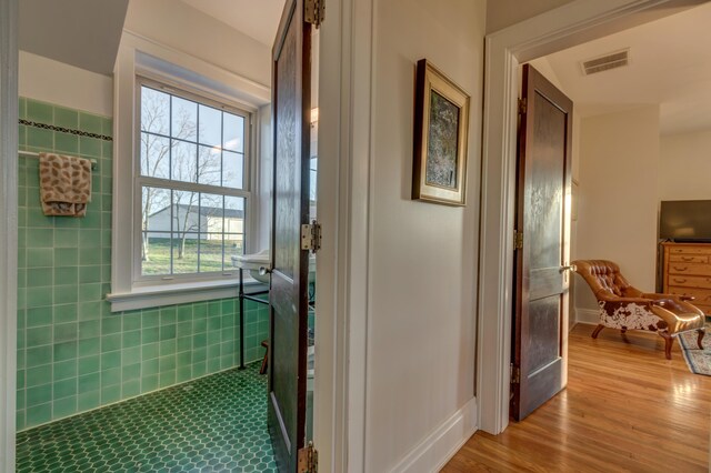 443 Hutchison Rd, Paris, KY 40361 - hall with wood finished floors, tile walls, and visible vents