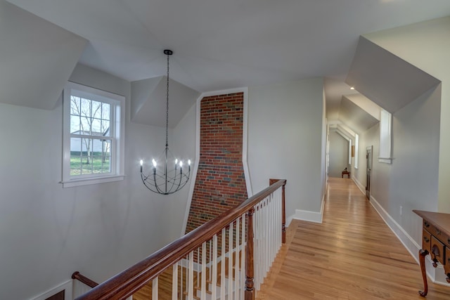 443 Hutchison Rd, Paris, KY 40361 - corridor featuring an upstairs landing, a chandelier, baseboards, light wood-type flooring, and vaulted ceiling