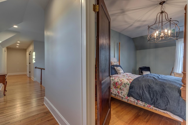 443 Hutchison Rd, Paris, KY 40361 - bedroom with baseboards, wood finished floors, and a chandelier