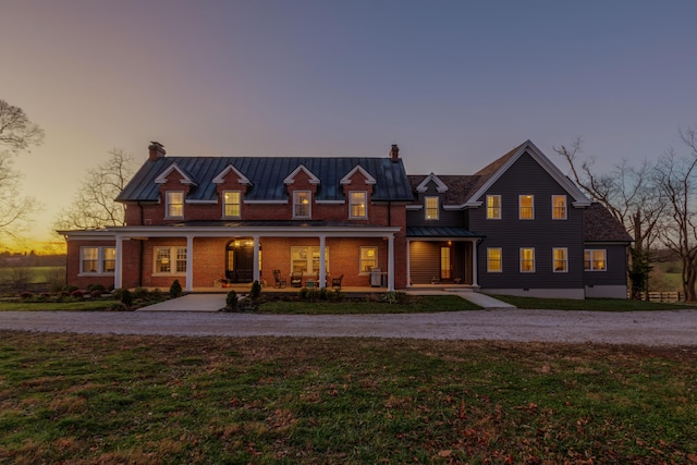 443 Hutchison Rd, Paris, KY 40361 - view of front facade featuring a standing seam roof, metal roof, a porch, a yard, and a chimney