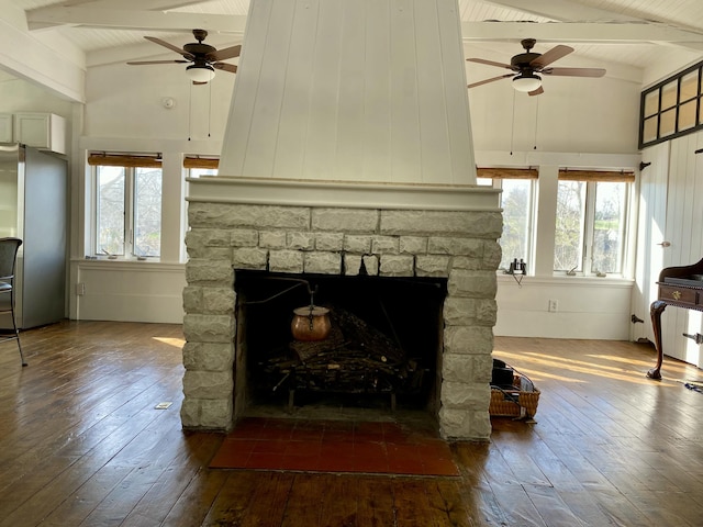 details with freestanding refrigerator, a ceiling fan, a fireplace, and wood finished floors