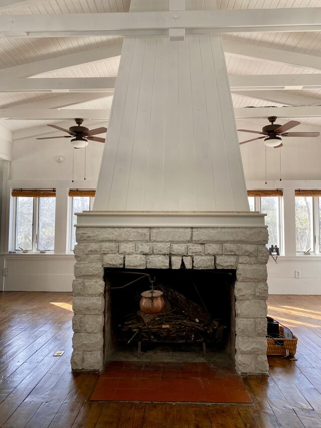 room details featuring a fireplace, wood finished floors, and ceiling fan