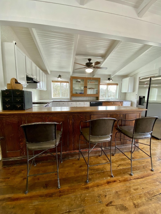 kitchen featuring wood-type flooring, white cabinets, plenty of natural light, and stainless steel refrigerator with ice dispenser
