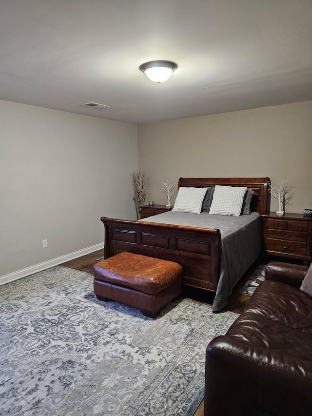 bedroom with baseboards and visible vents